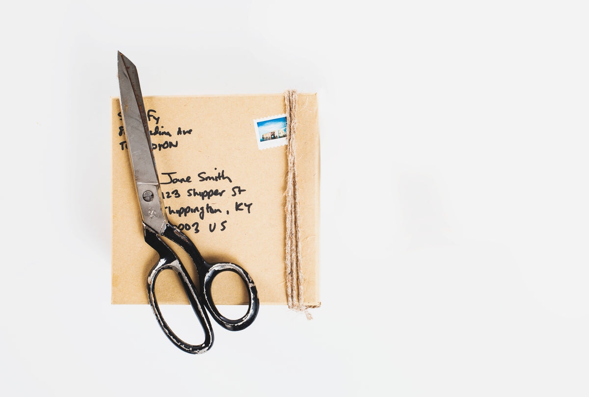 scissors on top of an envelope